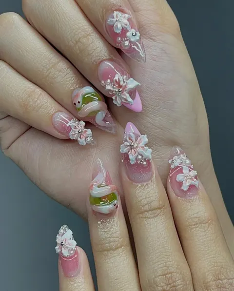 Pink almond nails with hand-sculpted 3D white flowers and pearls